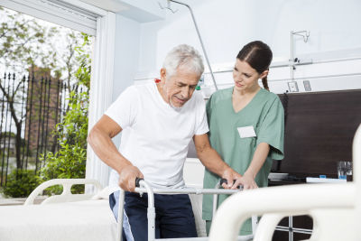 caregiver assisting senior walking